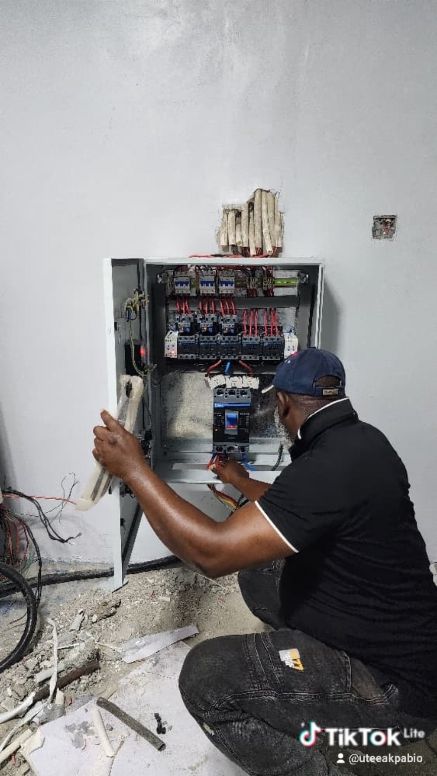 Technician working on electrical control panel
